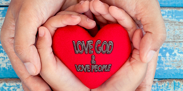 Red heart in child kid and mother hands on old blue wooden table in vintage retro style